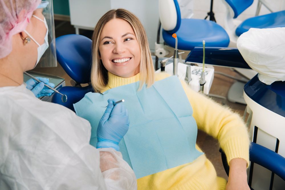 the-girl-smiles-at-the-dentist-and-looks-at-her-7WTGU43