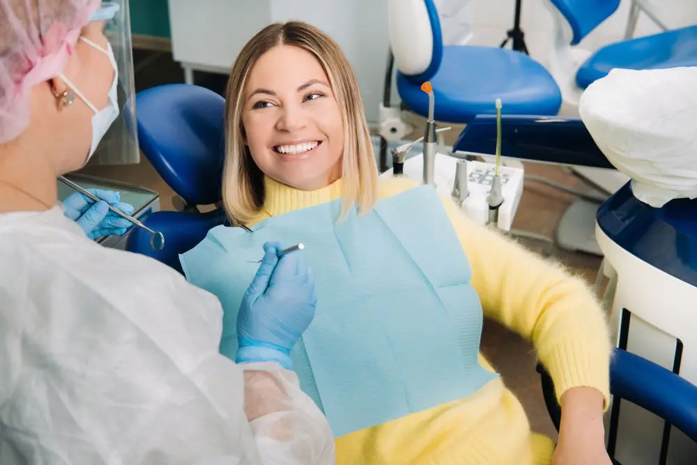 the-girl-smiles-at-the-dentist-and-looks-at-her-7WTGU43