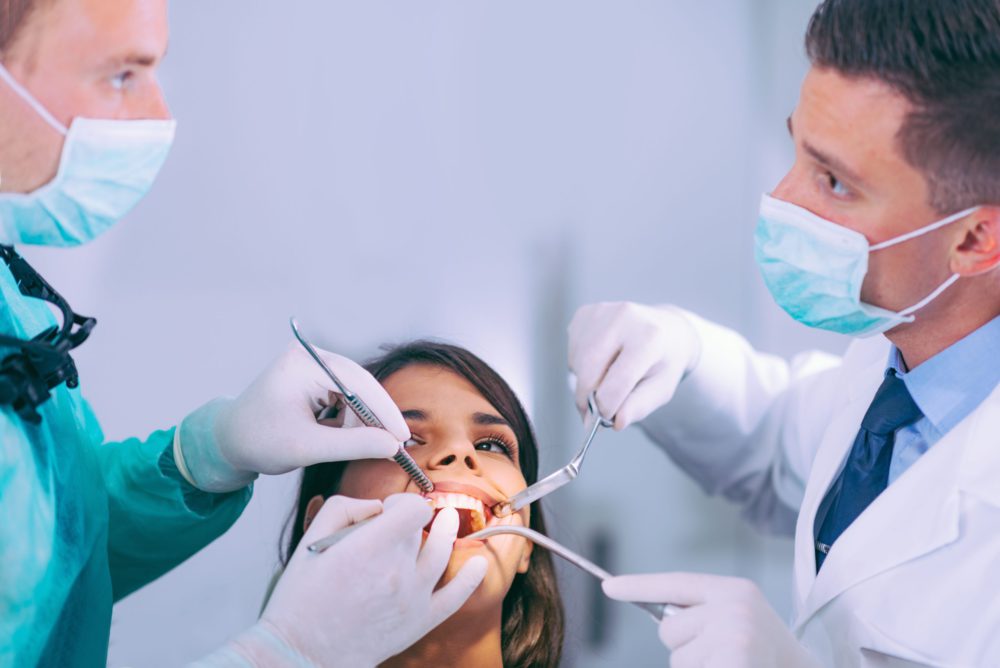 Dentists Working with Young Female Patient